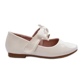 Children's patent white ballerina shoes with a Velcro bow