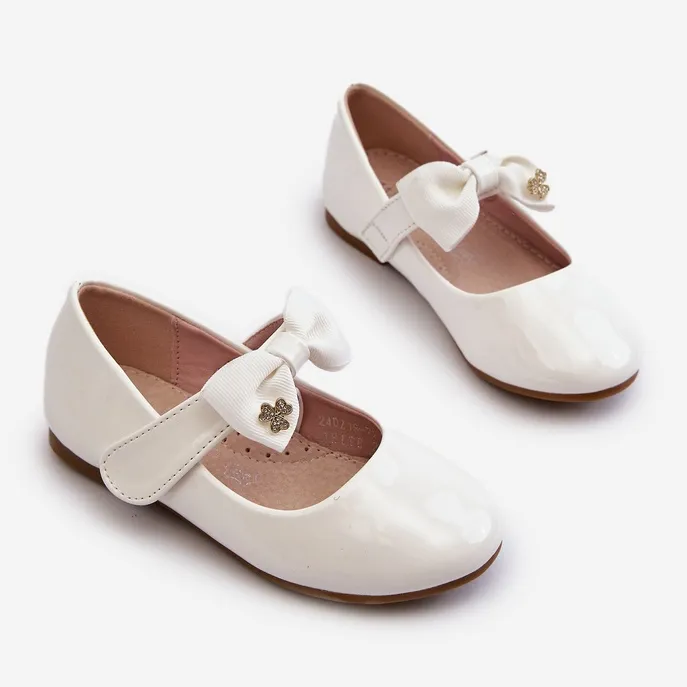 Children's patent white ballerina shoes with a Velcro bow