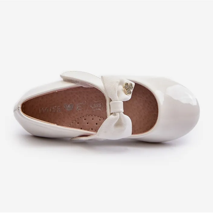 Children's patent white ballerina shoes with a Velcro bow