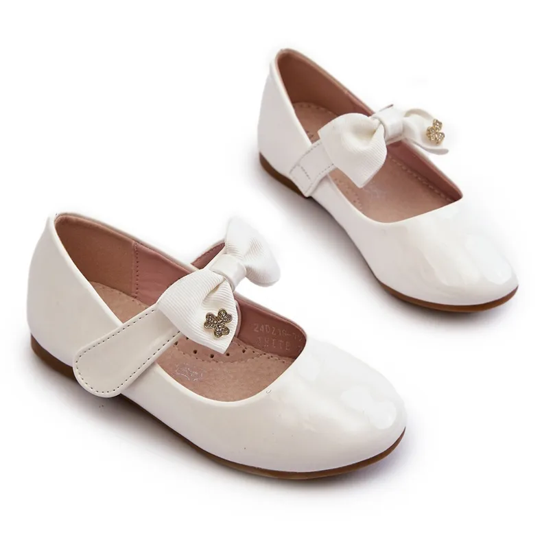 Children's patent white ballerina shoes with a Velcro bow